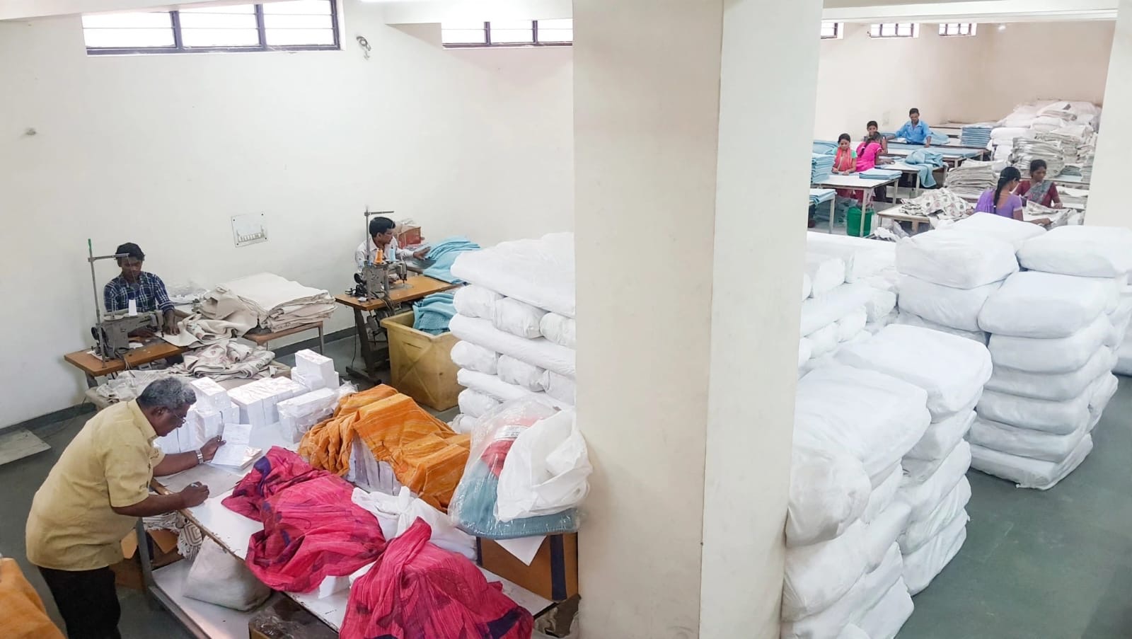 Team members finishing and packing textiles in the Veevin workshop