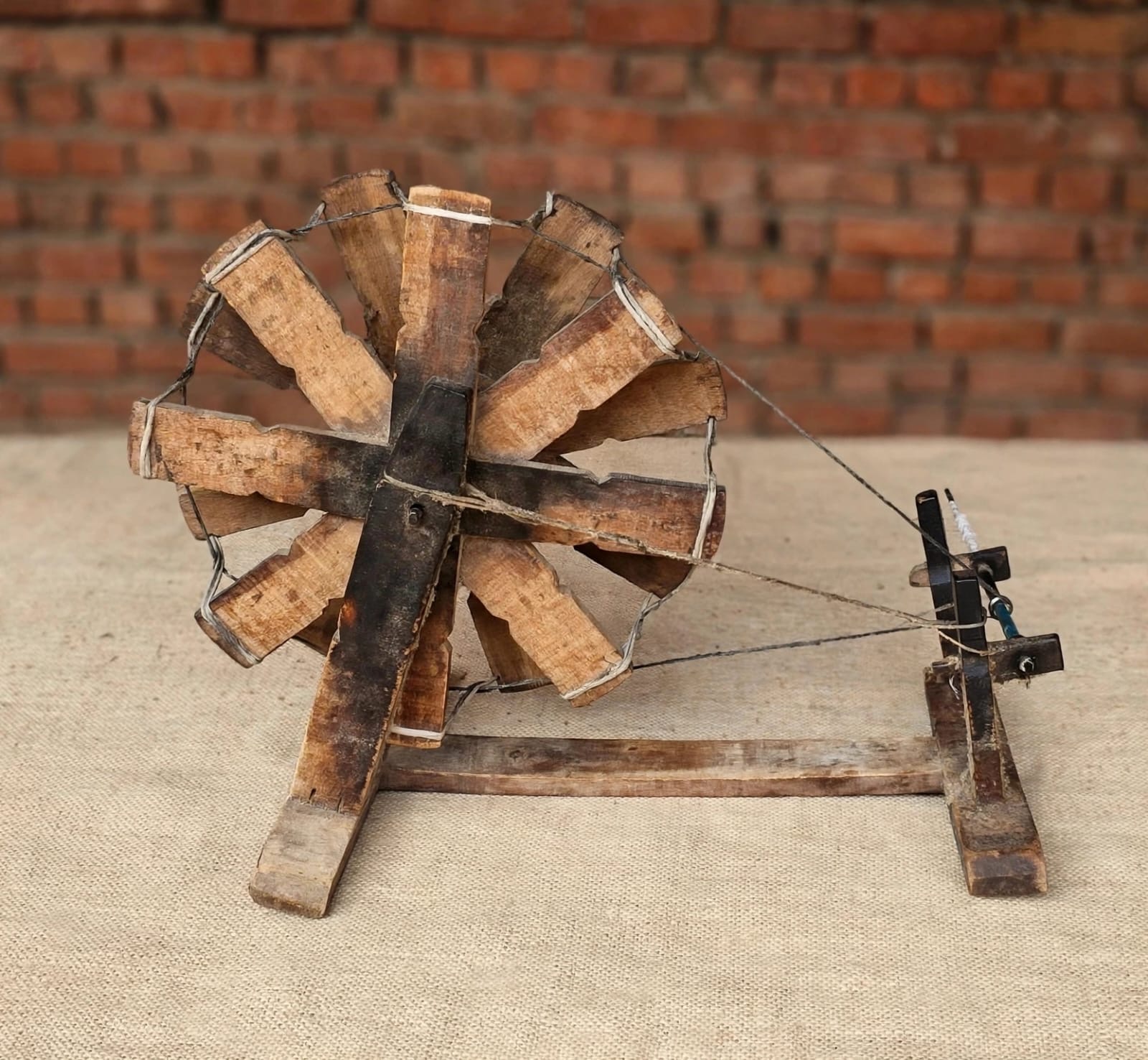 A wooden spinning wheel used in traditional textile making