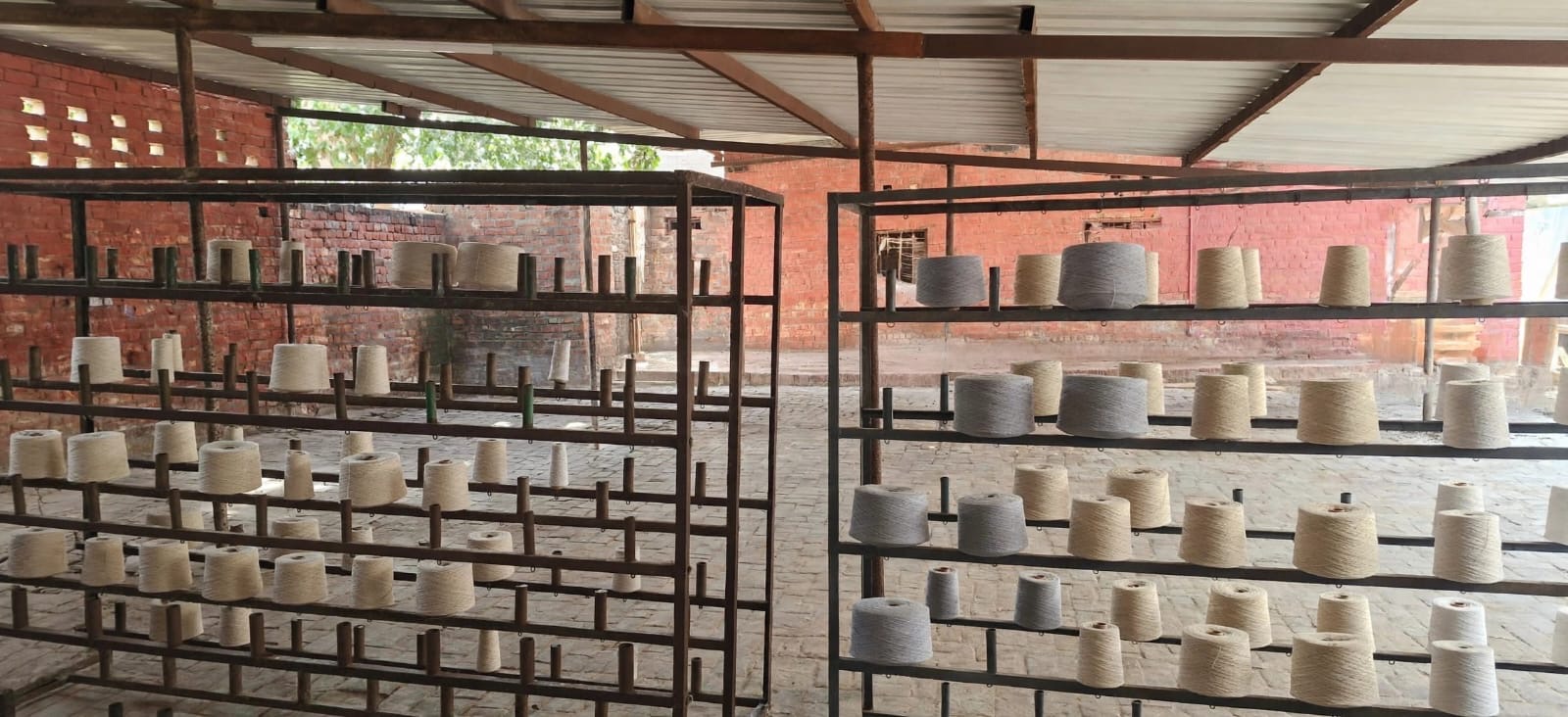 Spools of yarn arranged in the workshop