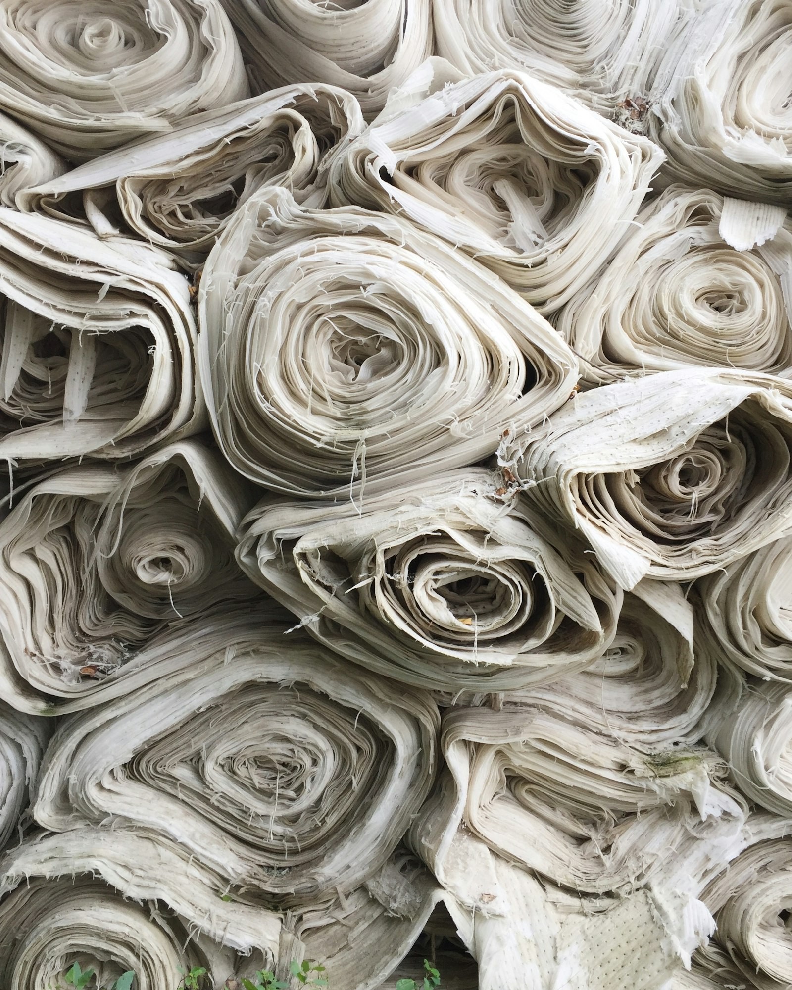 Stacked rolls of undyed cotton cloth